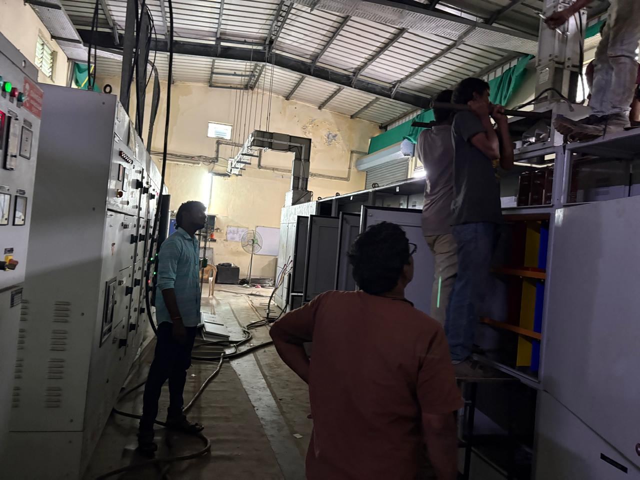 Workers handling cable drums at site